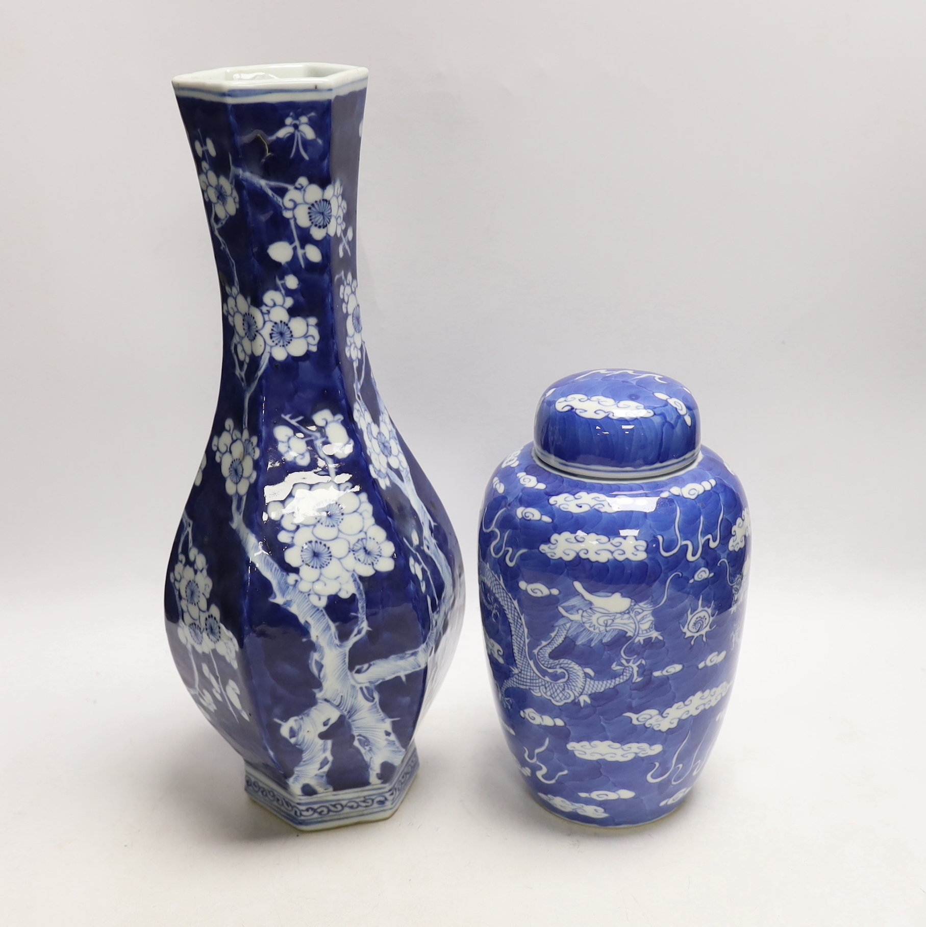 A Chinese blue and white hexagonal baluster vase, Qianlong mark, 19th century and a blue and white ‘dragon’ jar and cover, 19th century, tallest 36cm (2)